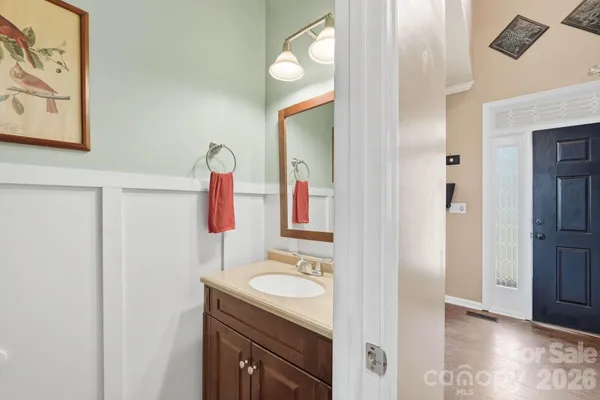 a bathroom with a sink vanity and mirror