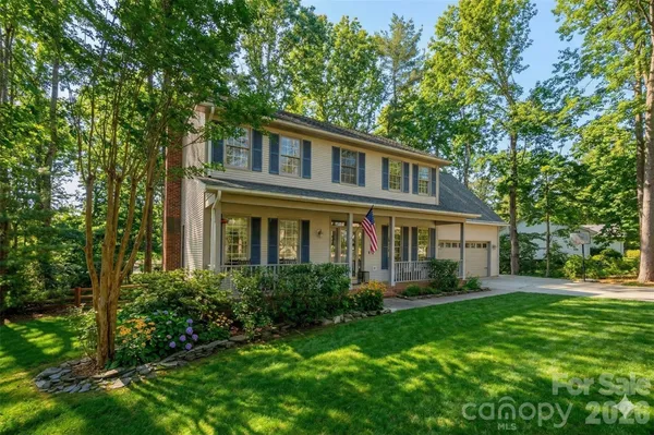 a front view of house with yard and green space