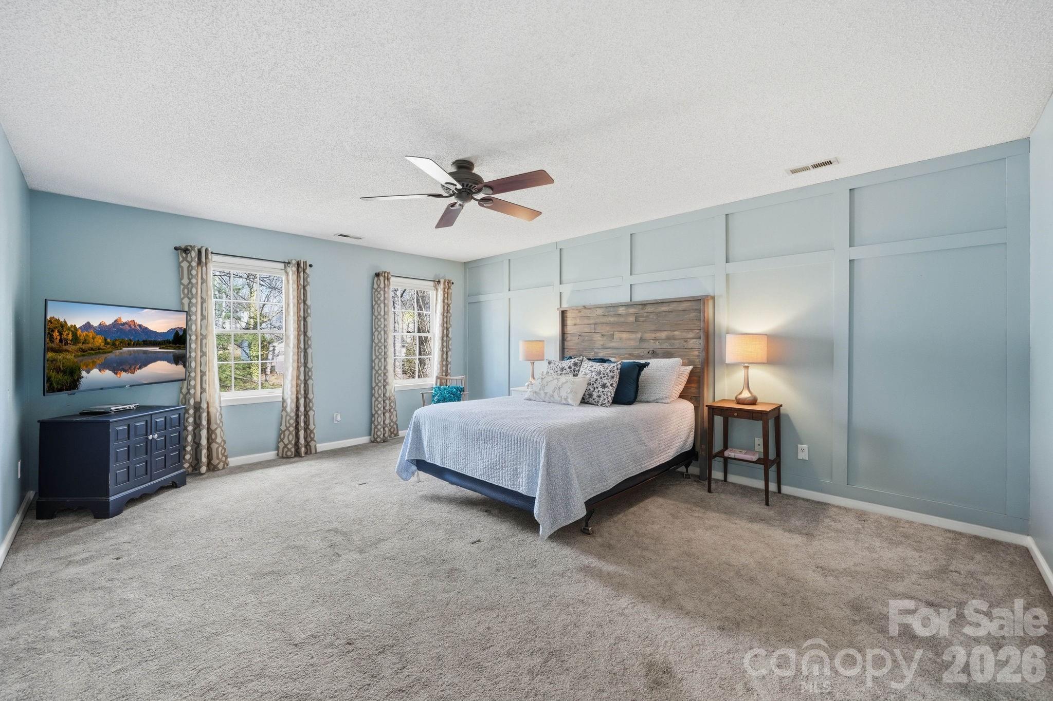 242 Windsor Forest Circle Fletcher, NC 28732 - Photo 22 of 43 a spacious bedroom with a bed and a chandelier