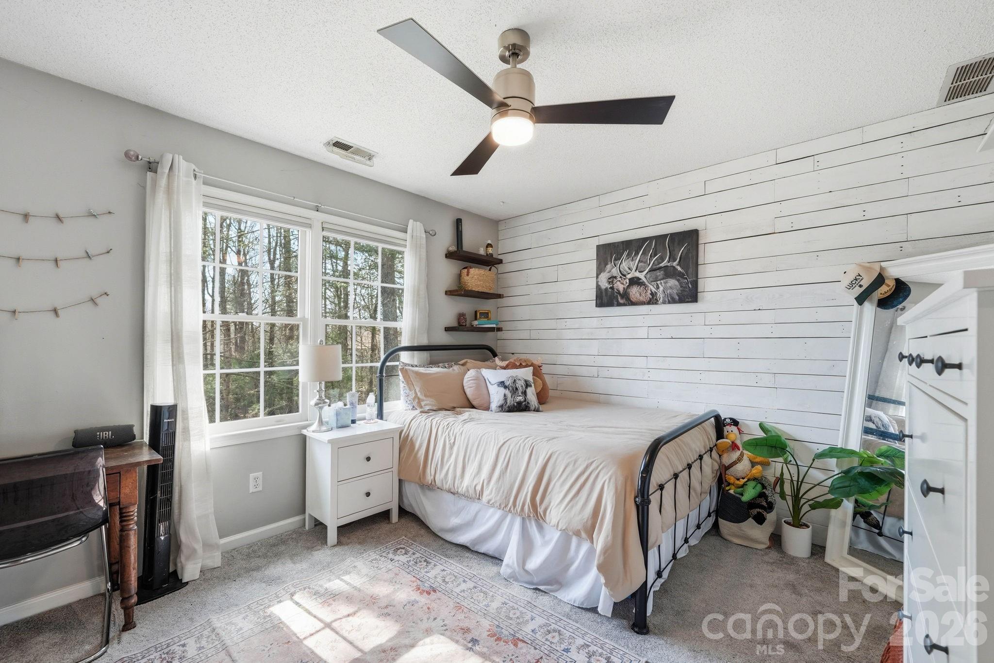 242 Windsor Forest Circle Fletcher, NC 28732 - Photo 29 of 43 a bedroom with a bed table and a window