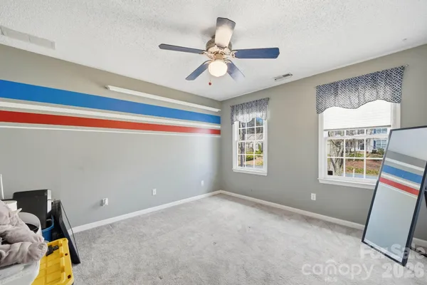 a view of room with window and ceiling fan