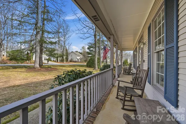 a view of a porch with furniture and garden