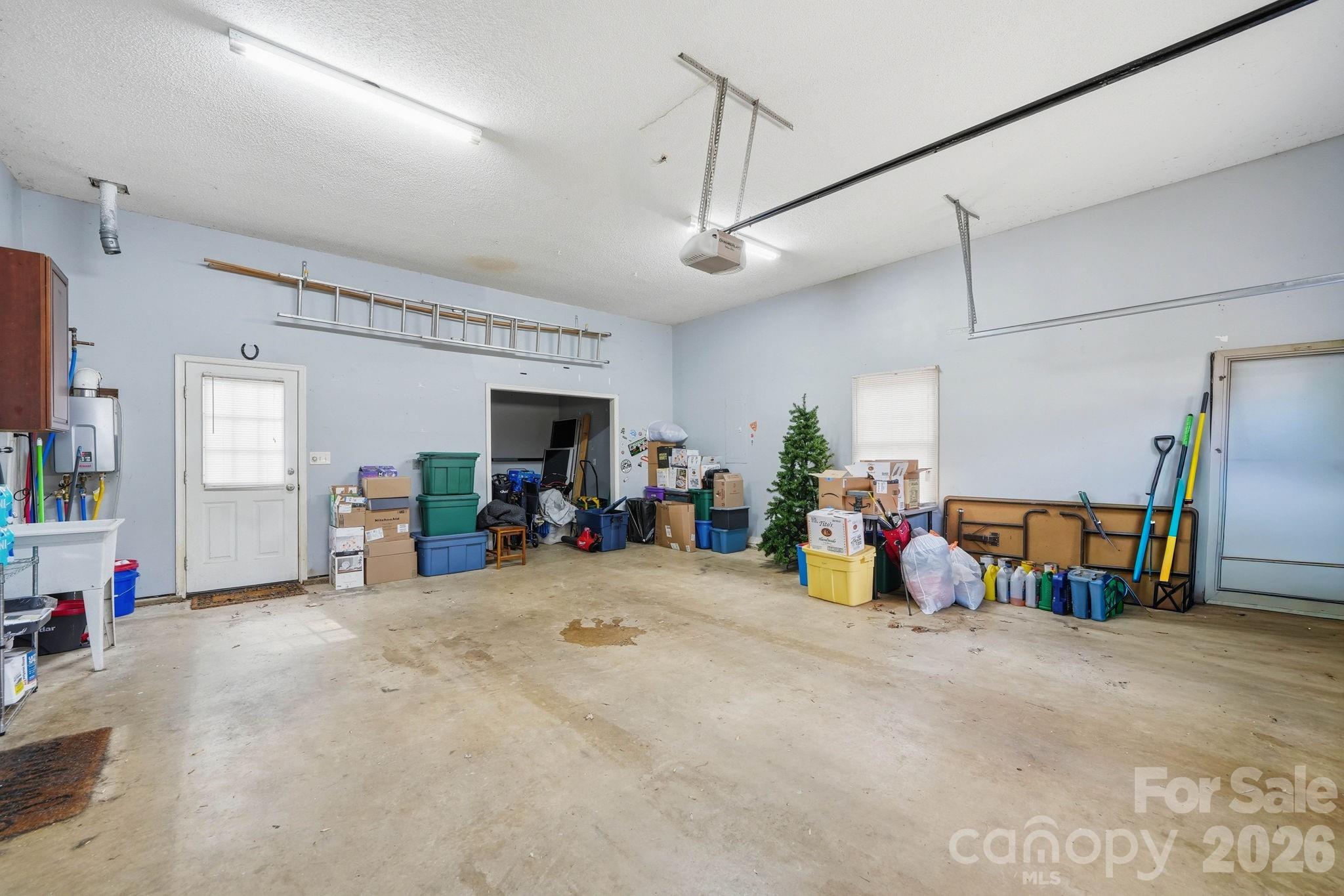 242 Windsor Forest Circle Fletcher, NC 28732 - Photo 37 of 43 a view of a garage with toys and a tv