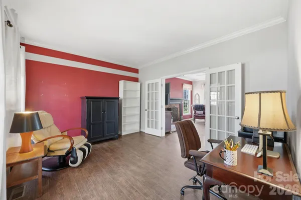 a view of a workspace with furniture and a window