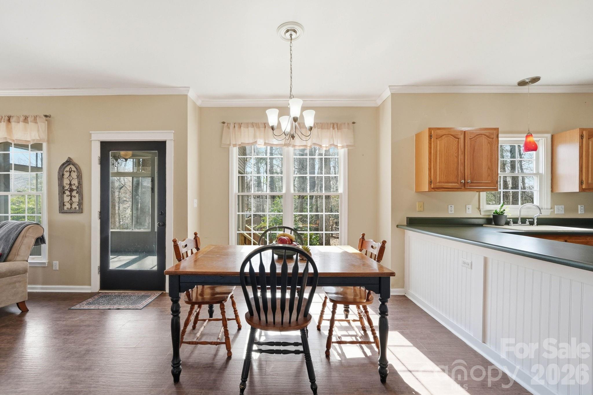 242 Windsor Forest Circle Fletcher, NC 28732 - Photo 10 of 43 a view of a dining room with furniture window and wooden floor