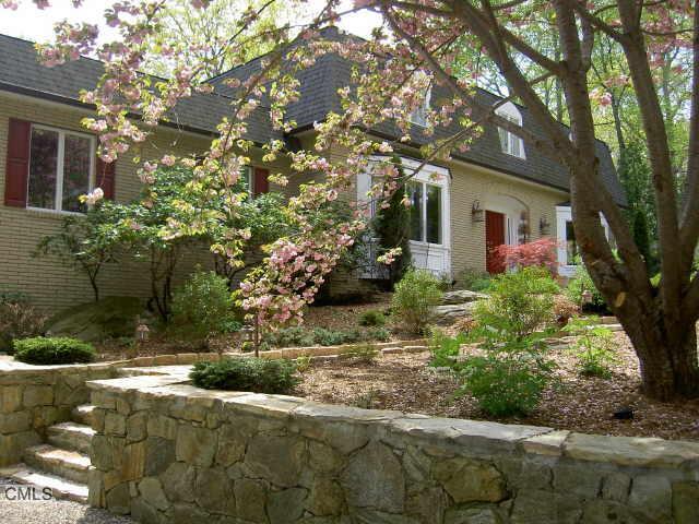 a front view of a house with yard and green space