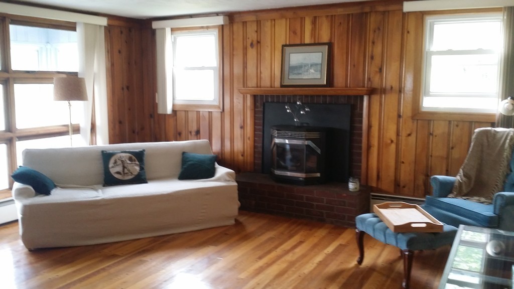 2 Boivin Avenue Ware, MA 01082 - Photo 13 of 21 a living room with furniture a flat screen tv and a fireplace