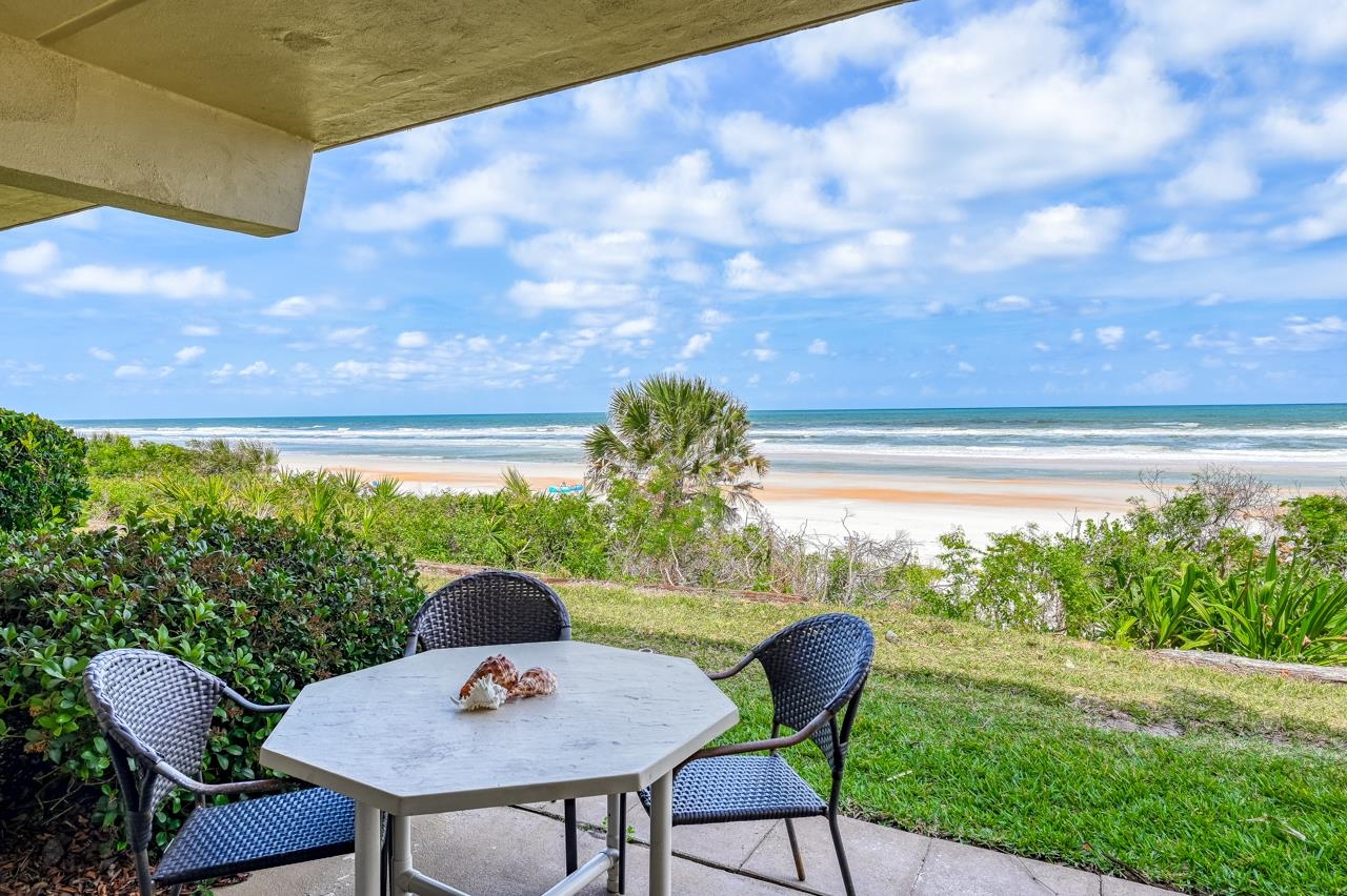 8550 A1A South, Unit 261 St. Augustine, FL 32080 - Photo 13 of 23 a table and chairs in a garden