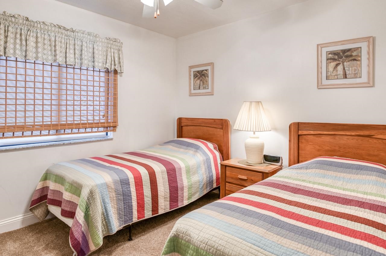 8550 A1A South, Unit 261 St. Augustine, FL 32080 - Photo 20 of 23 a bedroom with two beds and painting on the wall