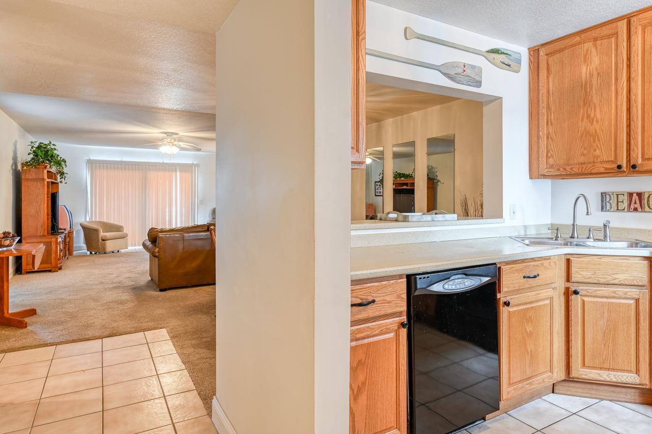 8550 A1A South, Unit 261 St. Augustine, FL 32080 - Photo 2 of 23 a kitchen with granite countertop a sink and a refrigerator
