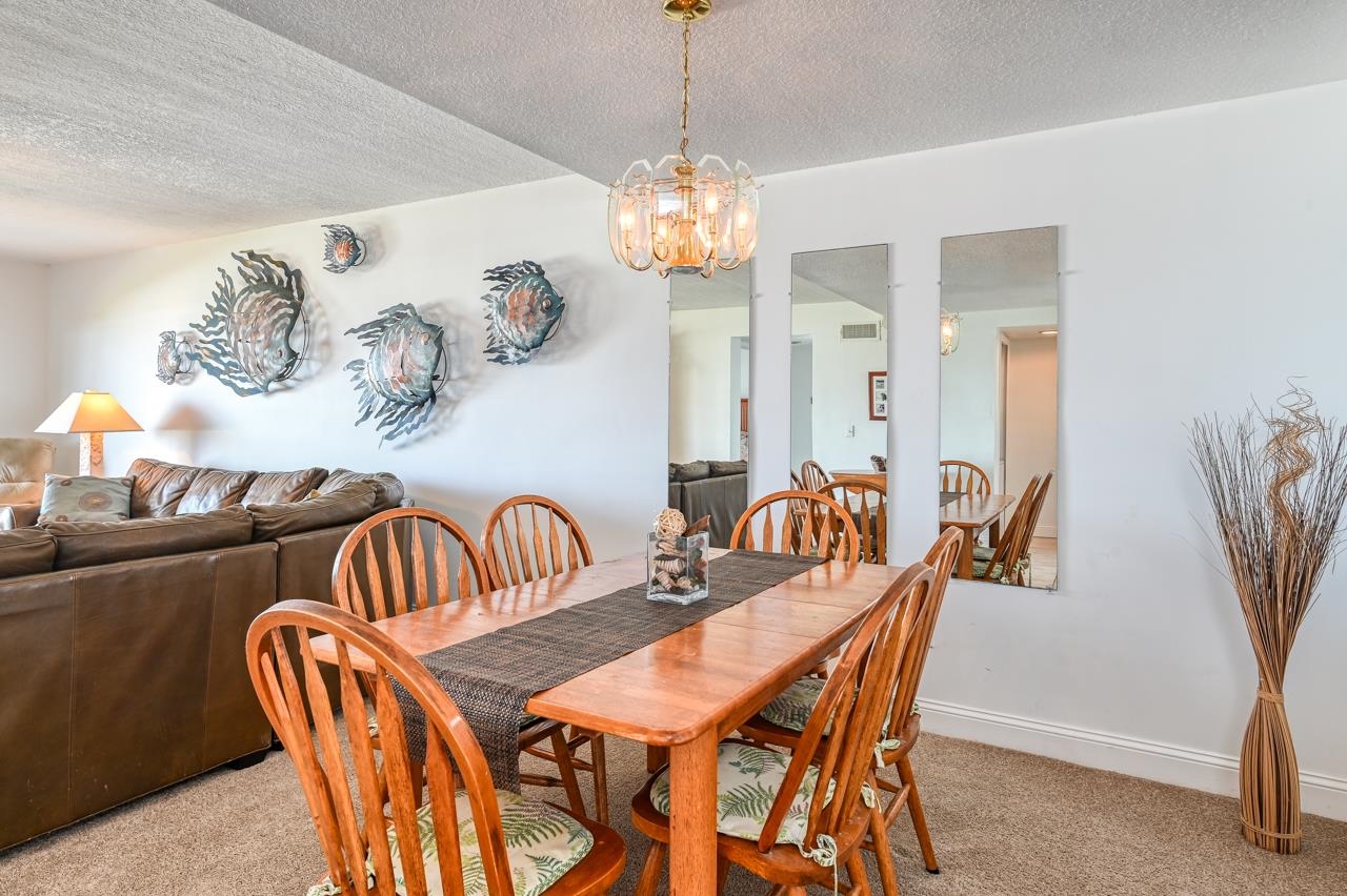 8550 A1A South, Unit 261 St. Augustine, FL 32080 - Photo 6 of 23 a dining room with furniture a chandelier and window