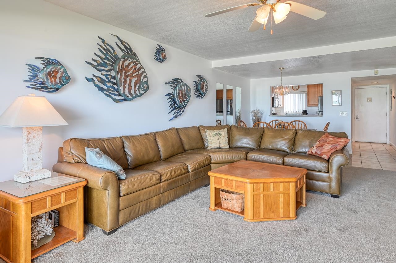 8550 A1A South, Unit 261 St. Augustine, FL 32080 - Photo 8 of 23 a living room with furniture and a chandelier