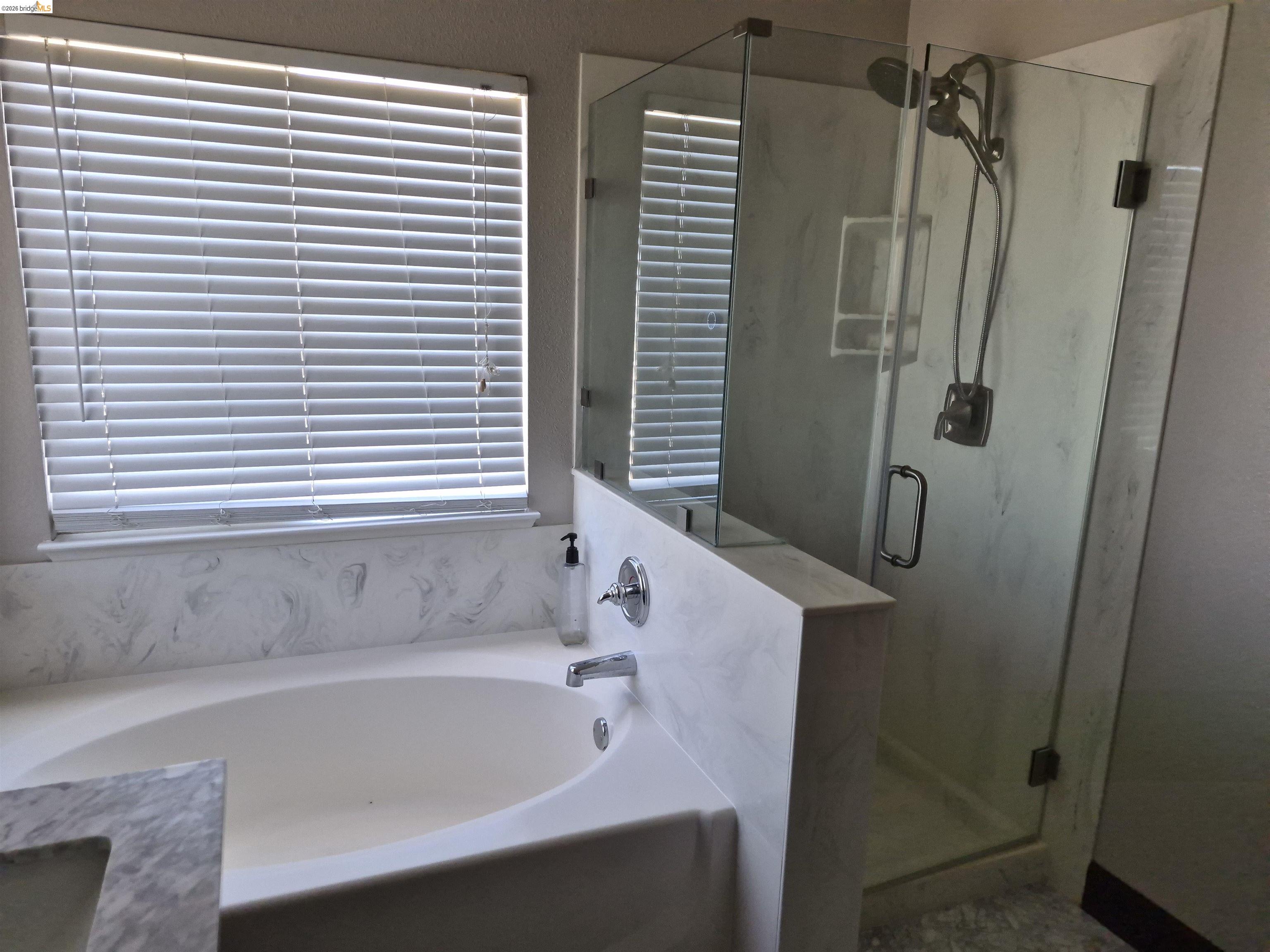149 Oakpoint Court Bay Point, CA 94565 - Photo 11 of 22 Soaking tub with a polished chrome faucet and a coordinating tile surround
