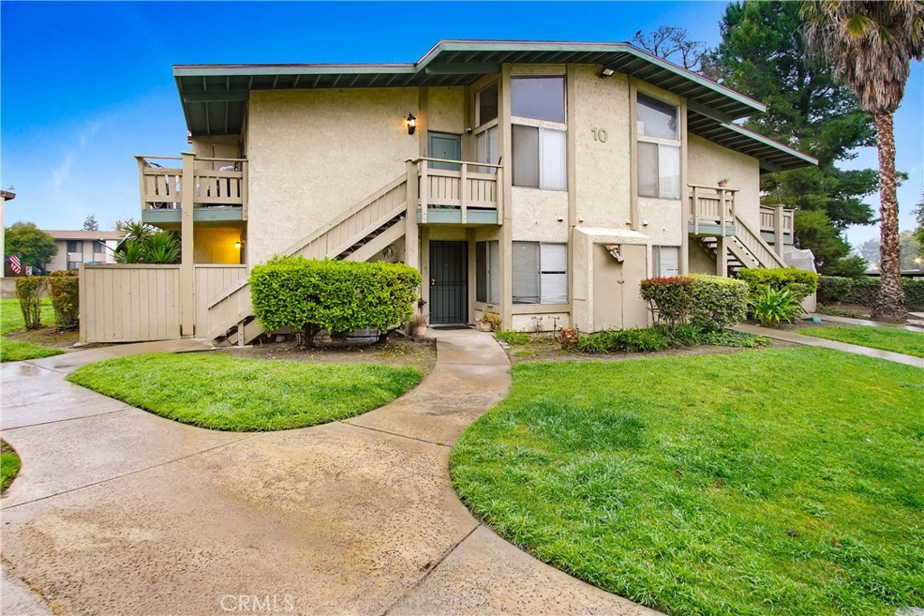 1800 East Old Ranch Road, Unit 165 Colton, CA 92324 - Photo 1 of 1 a view of a white house with large windows and a yard