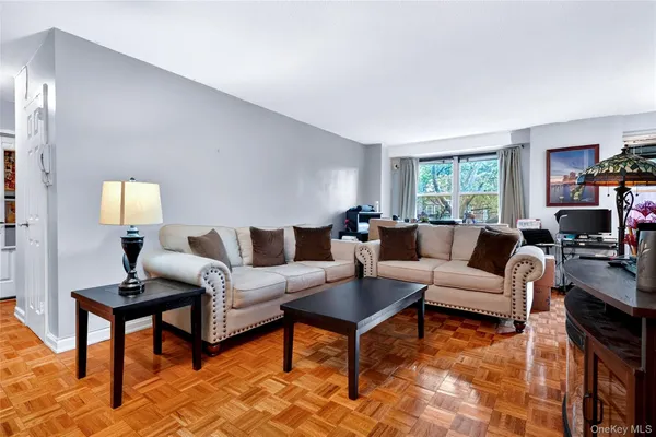 a living room with furniture and a lamp