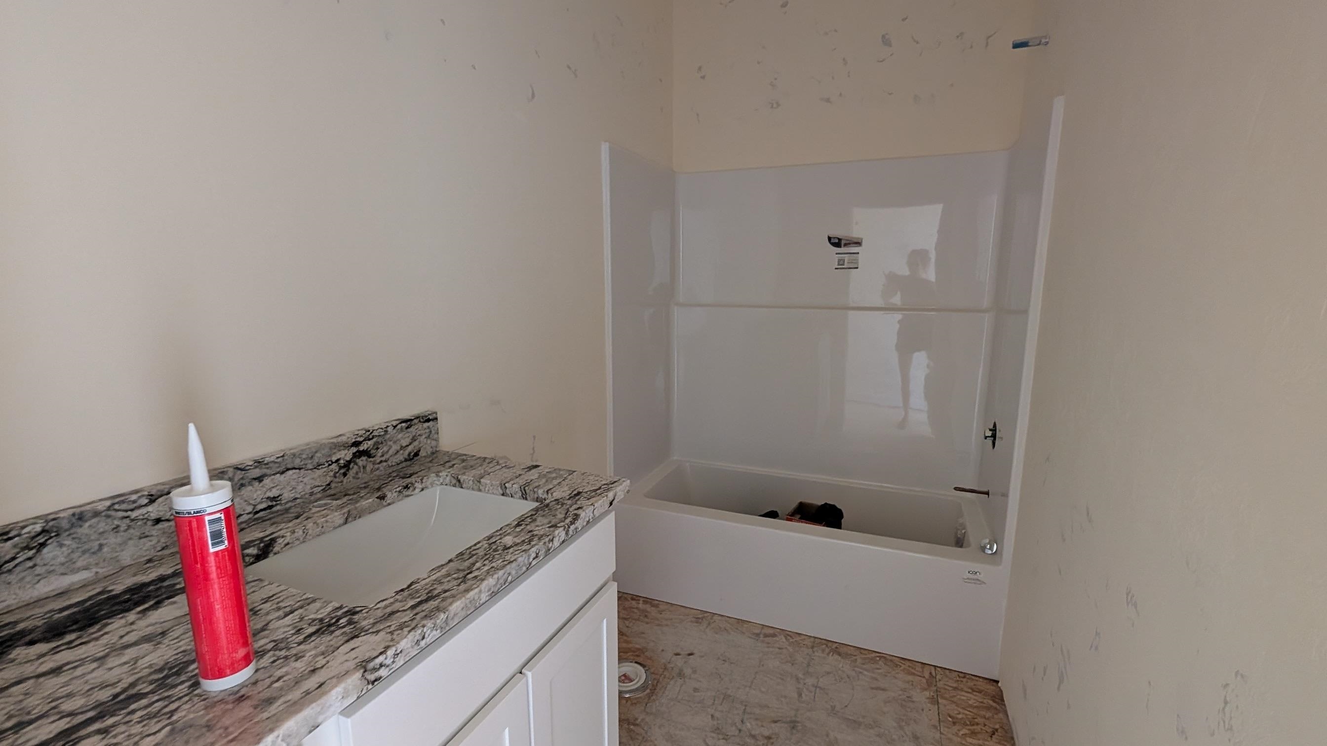 2456 Hamilton Road, Unit A Grand Junction, CO 81505 - Photo 11 of 13 a bathroom with a granite countertop tub and sink