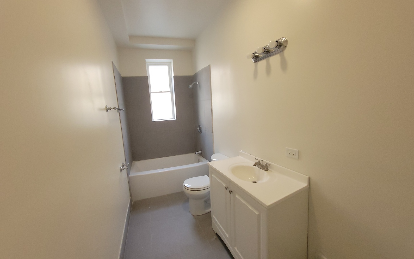 3840 West Roosevelt Road, Unit A Chicago, IL 60624 - Photo 5 of 7 a bathroom with a sink a toilet and shower