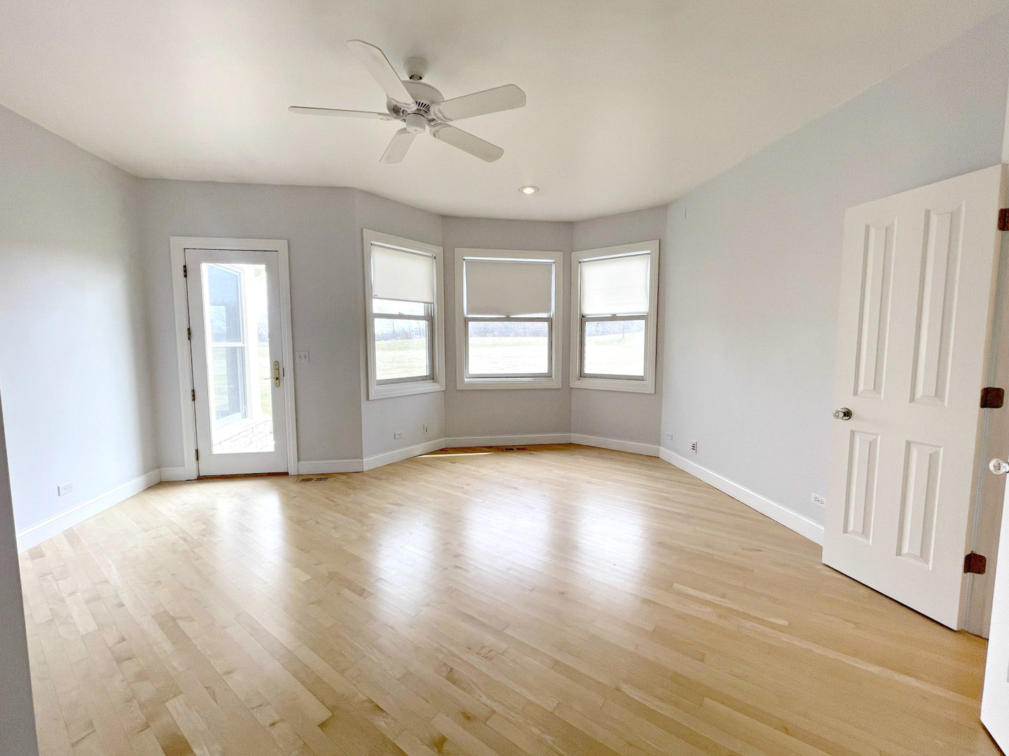 8208 Eagle Ridge Spring Grove, IL 60081 - Photo 19 of 39 a view of empty room with wooden floor and fan
