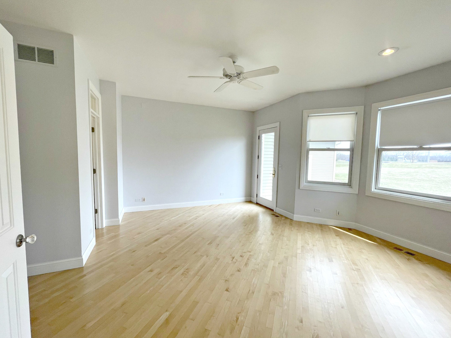 8208 Eagle Ridge Spring Grove, IL 60081 - Photo 20 of 39 a view of an empty room with a window and wooden floor