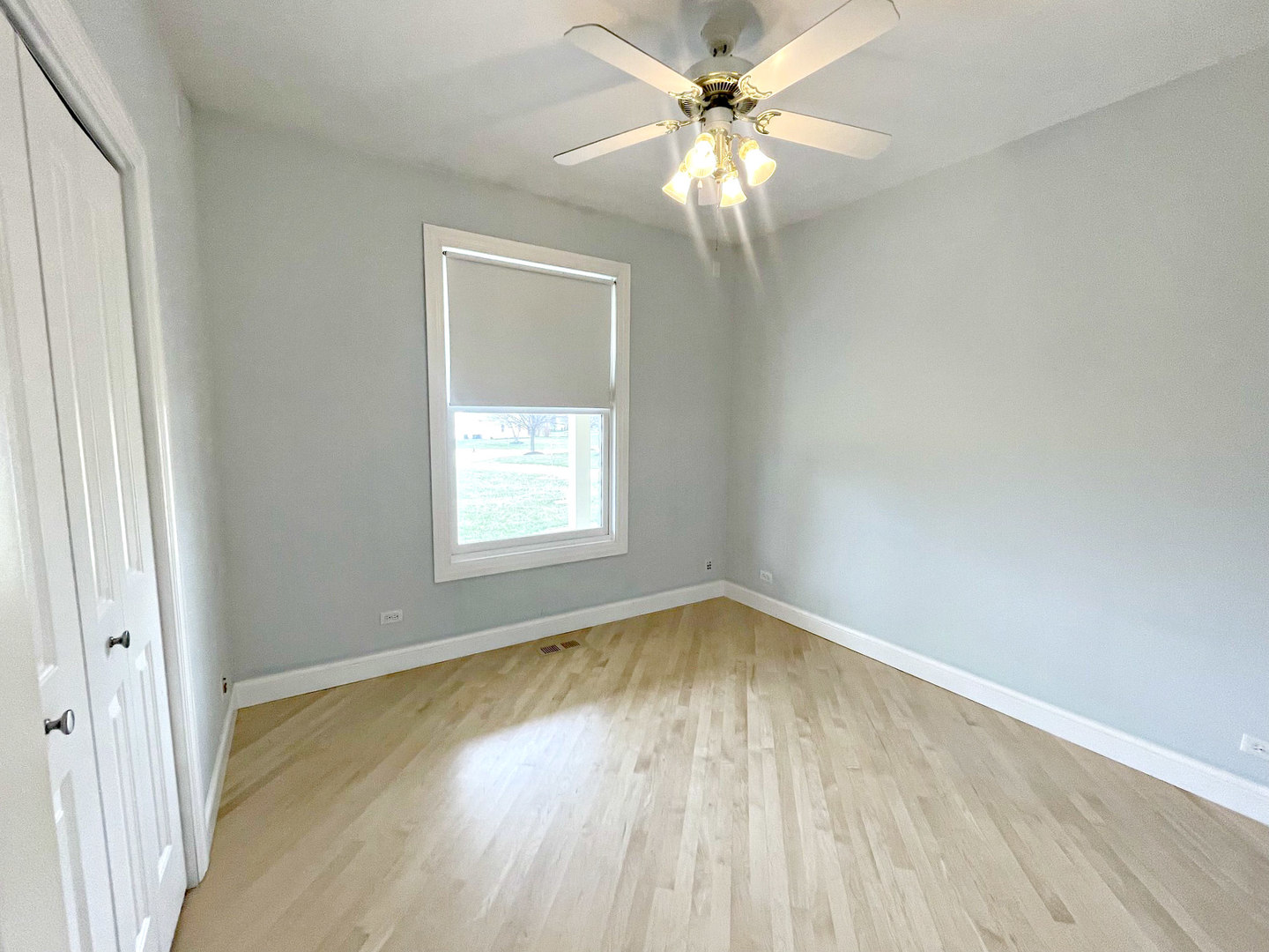 8208 Eagle Ridge Spring Grove, IL 60081 - Photo 25 of 39 an empty room with wooden floor fan and windows
