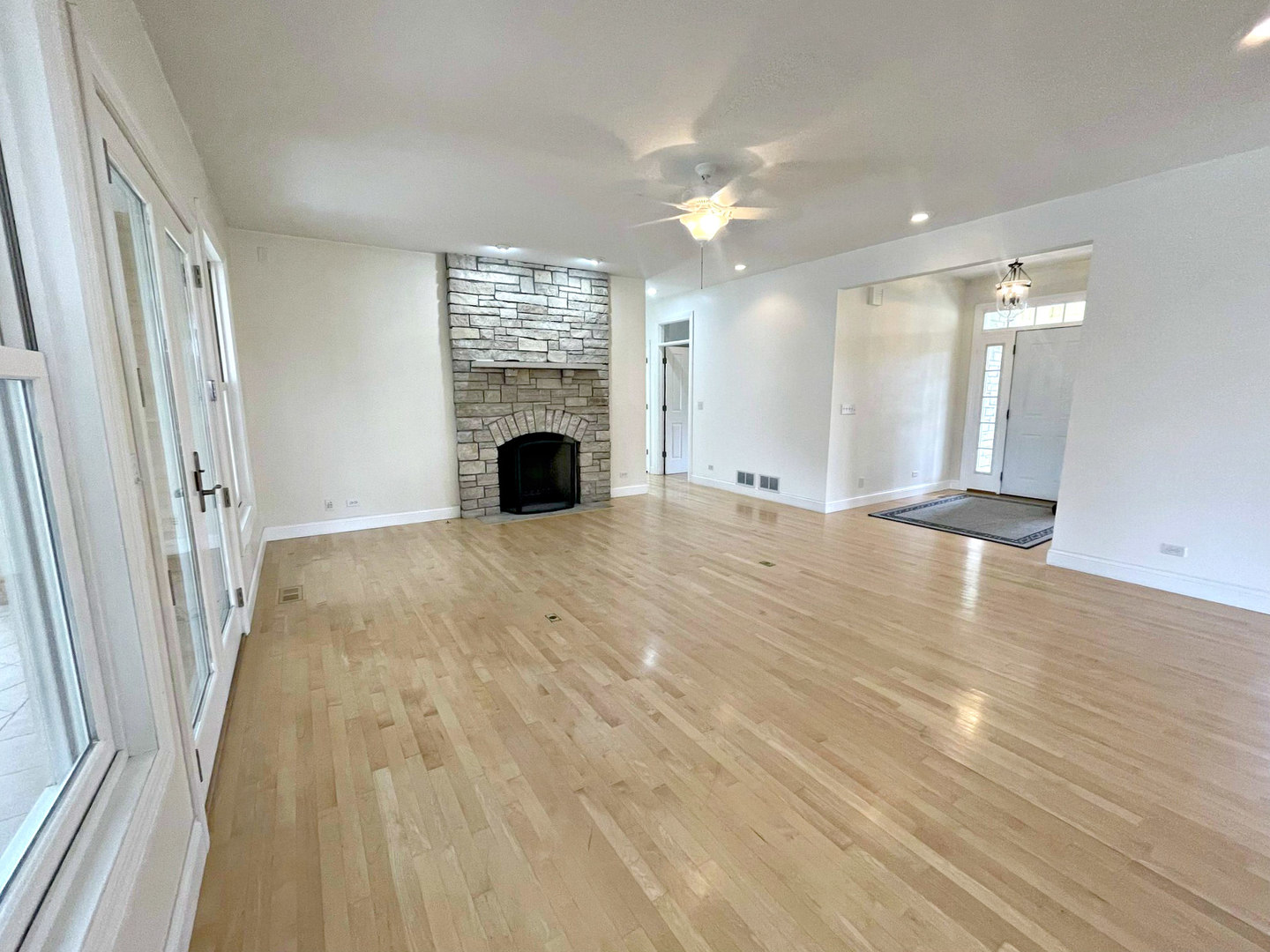 8208 Eagle Ridge Spring Grove, IL 60081 - Photo 7 of 39 a view of an empty room with wooden floor and a window