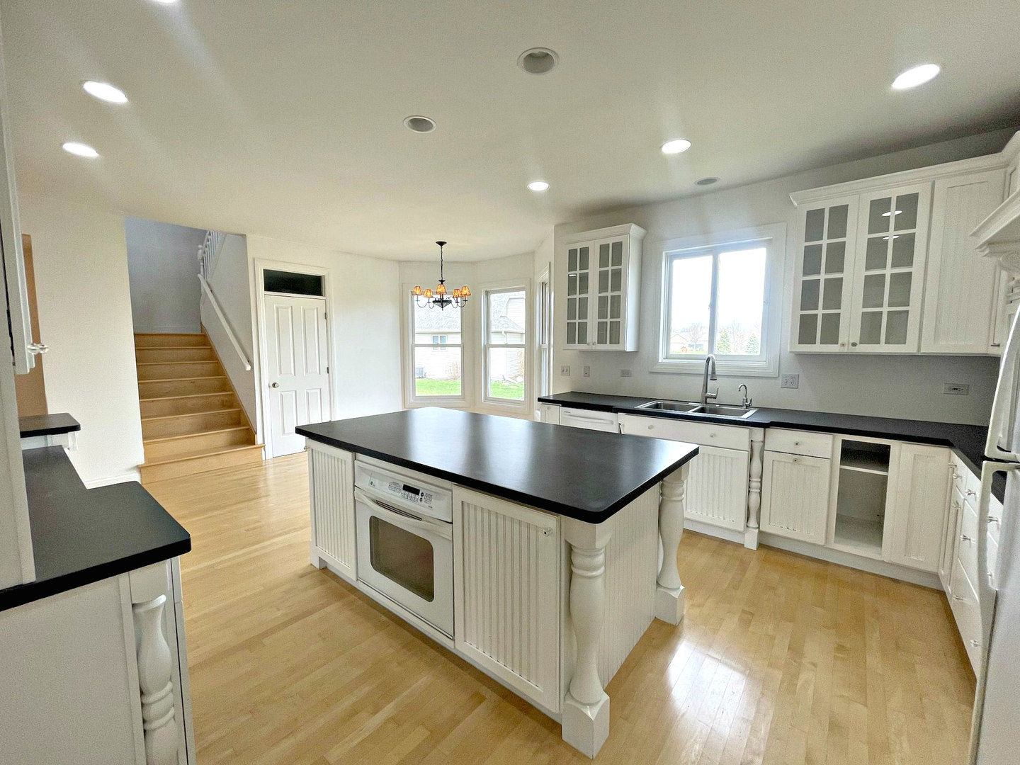8208 Eagle Ridge Spring Grove, IL 60081 - Photo 8 of 39 a kitchen with stainless steel appliances granite countertop a sink a stove and a wooden floors