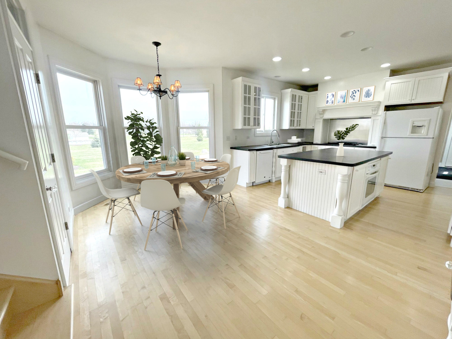 8208 Eagle Ridge Spring Grove, IL 60081 - Photo 10 of 39 a large white kitchen with granite countertop a stove a sink a refrigerator and white cabinets with wooden floor