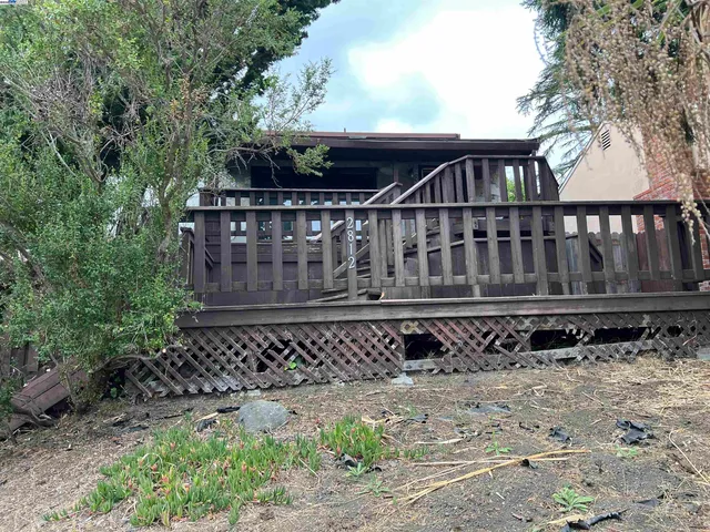 a side of a house with a bench
