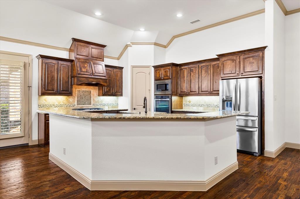 6814 Springwood Lane Garland, TX 75044 - Photo 15 of 35 a kitchen with stainless steel appliances granite countertop a stove a sink and a refrigerator