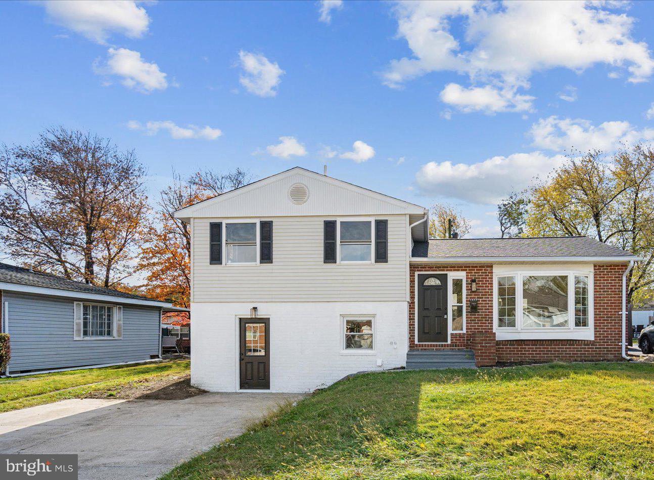 a view of a house with a swimming pool and a yard