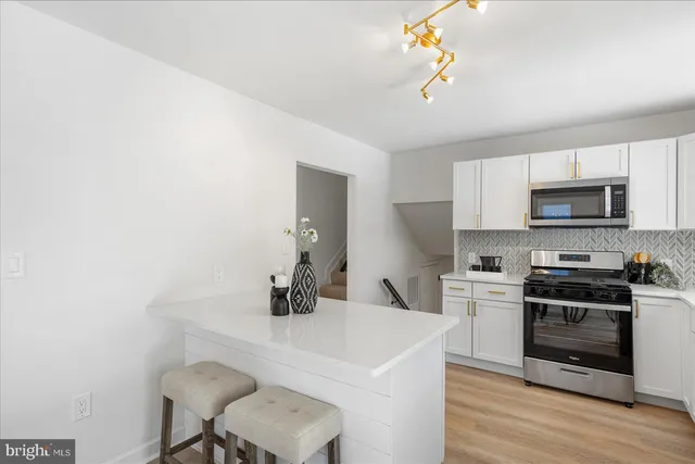 a kitchen with a sink cabinets and wooden floor