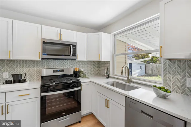 a kitchen with a sink stove and microwave