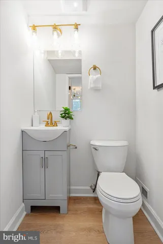 a bathroom with a sink a toilet and mirror