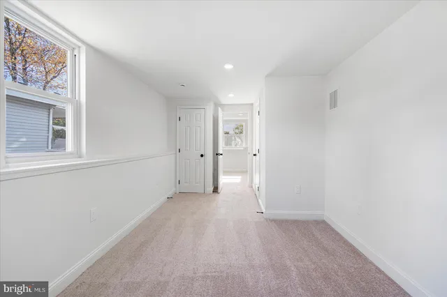 a view of a big room with closet and windows