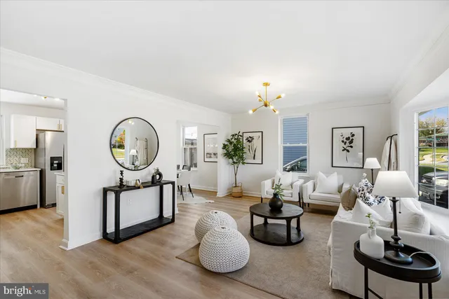 a living room with furniture a chandelier and a mirror