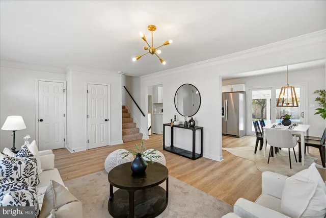 a living room with furniture a mirror and a window