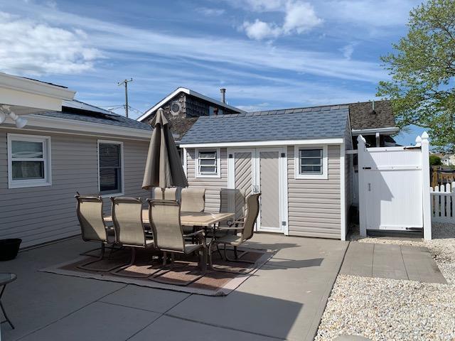 102 Bloomfield Road Barnegat, NJ 08005 - Photo 11 of 29 a view of a patio with table and chairs and barbeque oven