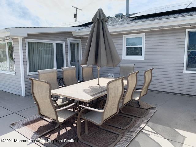 102 Bloomfield Road Barnegat, NJ 08005 - Photo 9 of 29 a view of a patio with table and chairs with wooden floor and fence