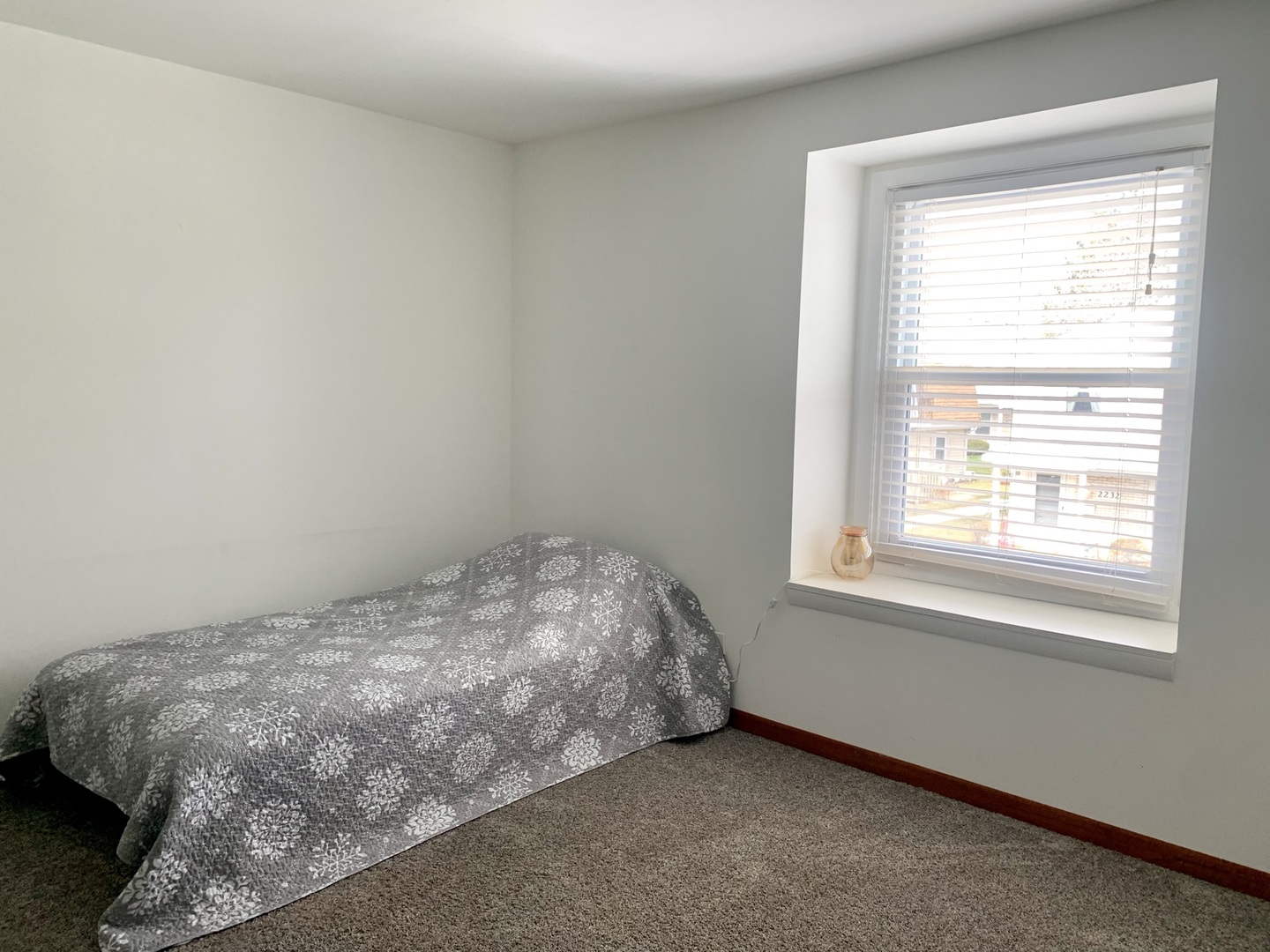 2231 Flower Court, Unit 2231 Schaumburg, IL 60107 - Photo 17 of 24 a bed sitting in a bedroom next to a window