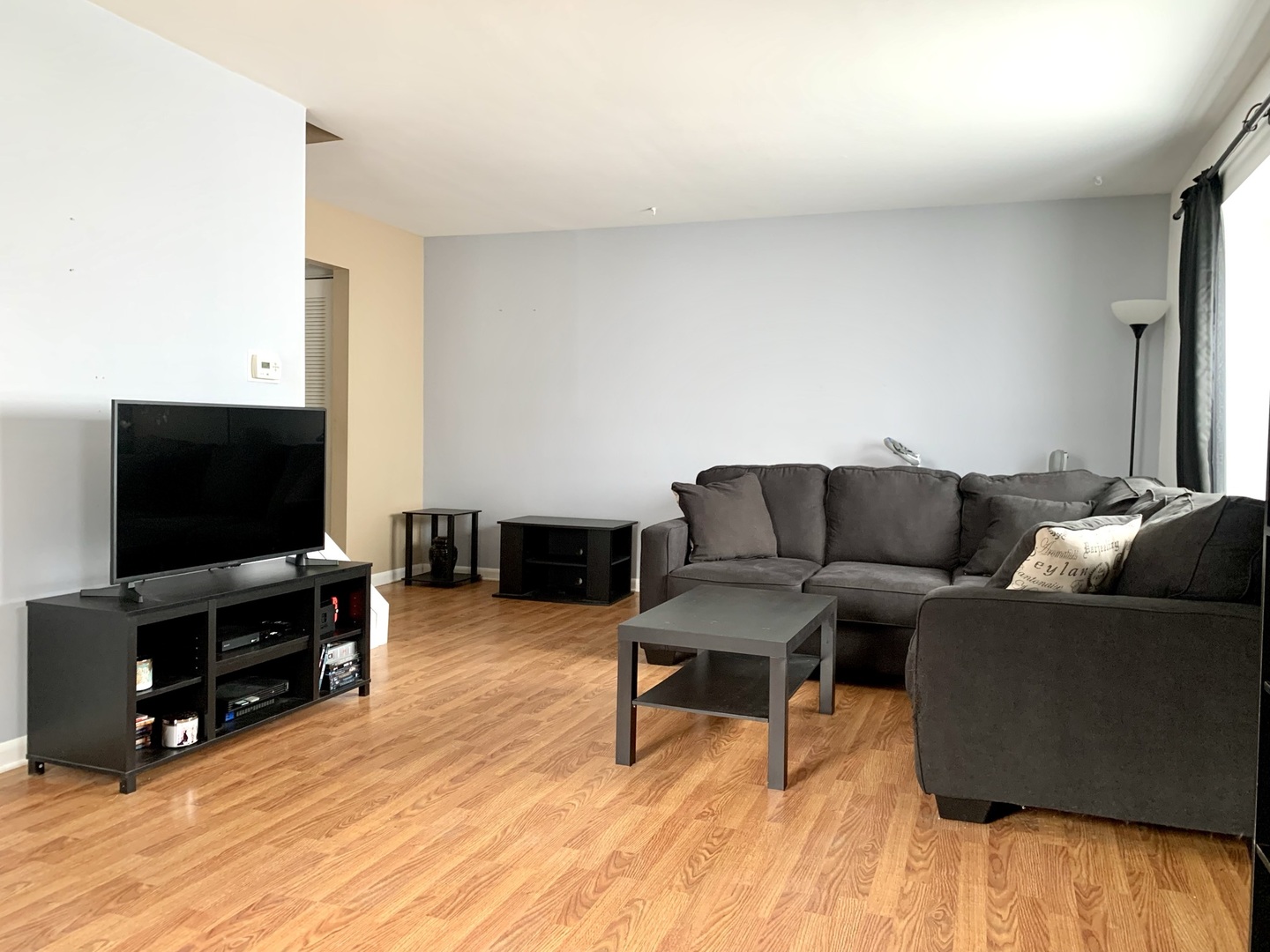 2231 Flower Court, Unit 2231 Schaumburg, IL 60107 - Photo 2 of 24 a living room with furniture and a flat screen tv
