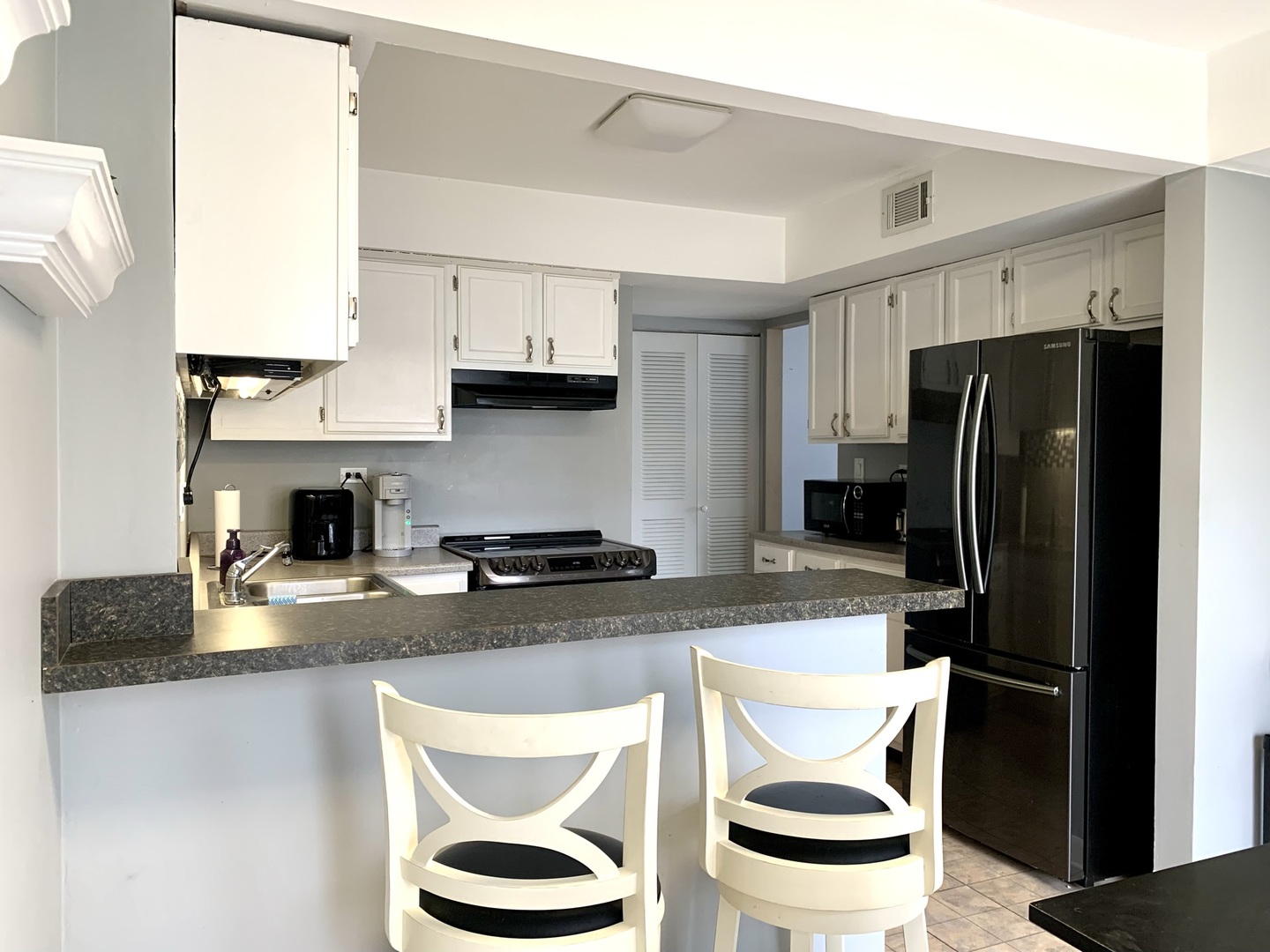 2231 Flower Court, Unit 2231 Schaumburg, IL 60107 - Photo 6 of 24 a kitchen with stainless steel appliances granite countertop a refrigerator a stove and a sink
