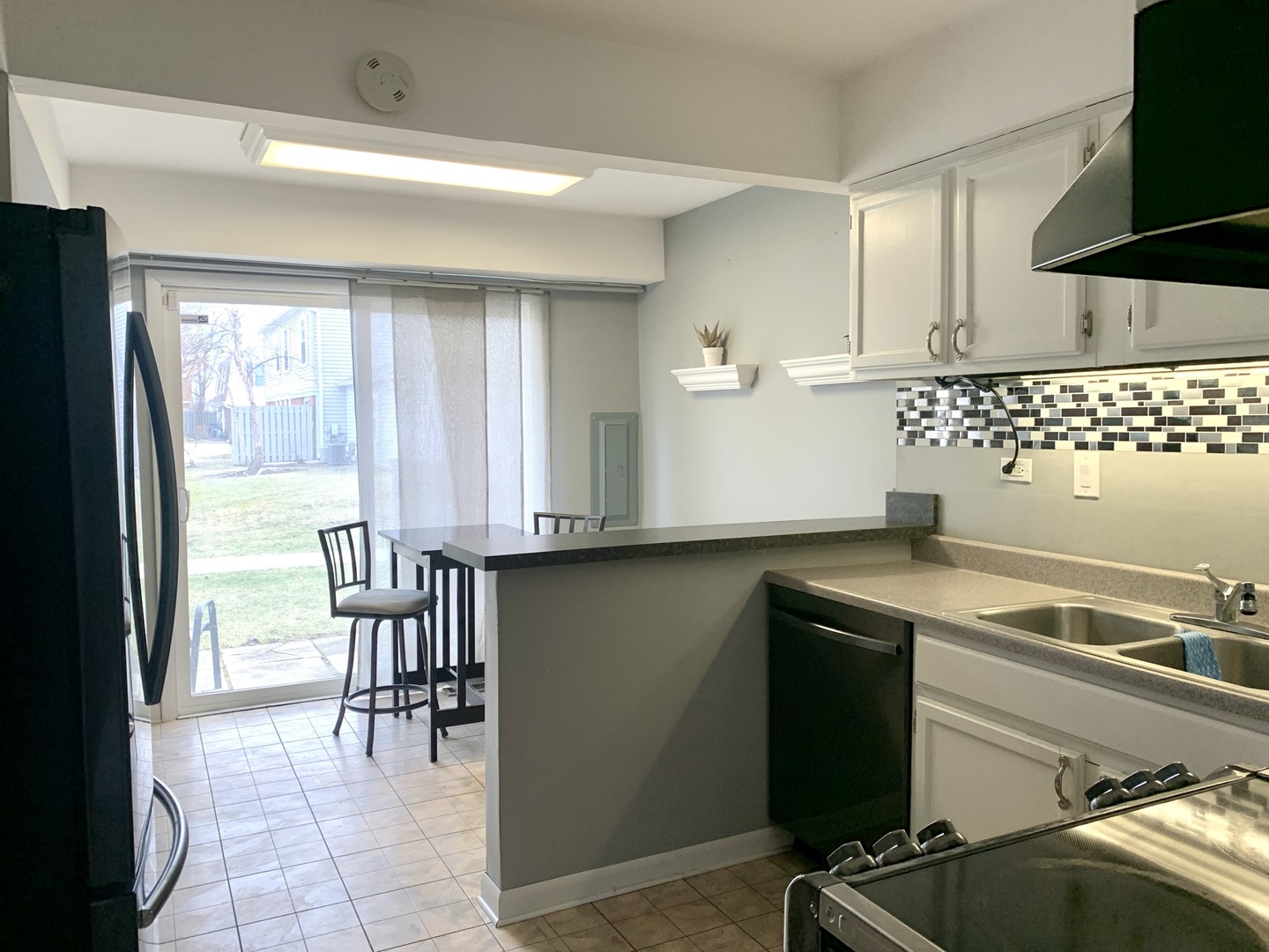 2231 Flower Court, Unit 2231 Schaumburg, IL 60107 - Photo 7 of 24 a kitchen with a sink cabinets and a table