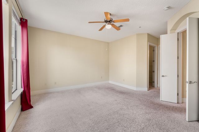 a view of a livingroom with a ceiling fan and window