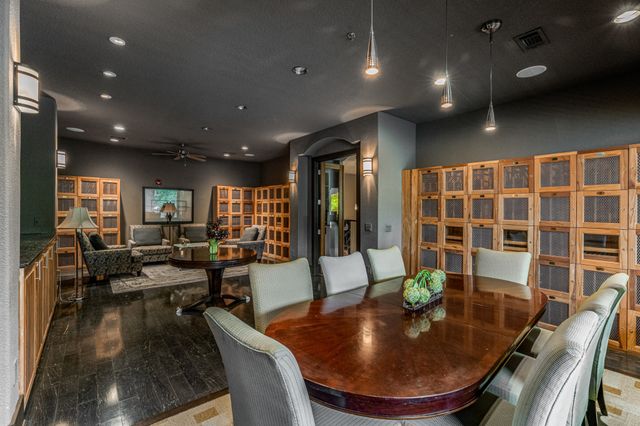 a large dining space with furniture a rug and wooden floor