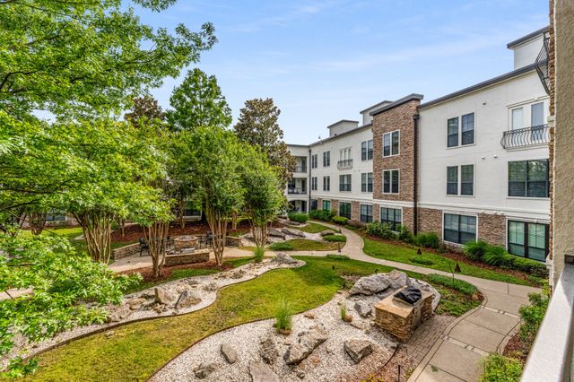 a view of a house with swimming pool and sitting area