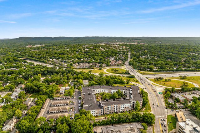 an aerial view of residential houses with outdoor space and swimming pool