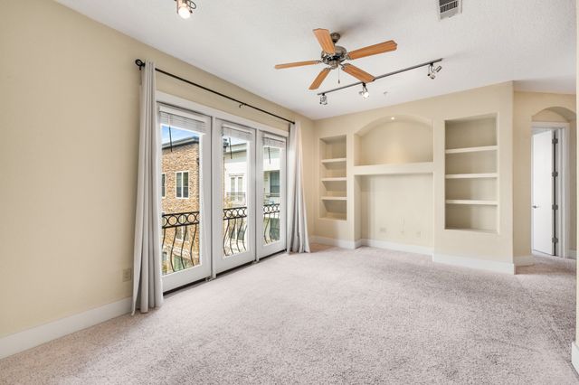 an empty room with closet and windows