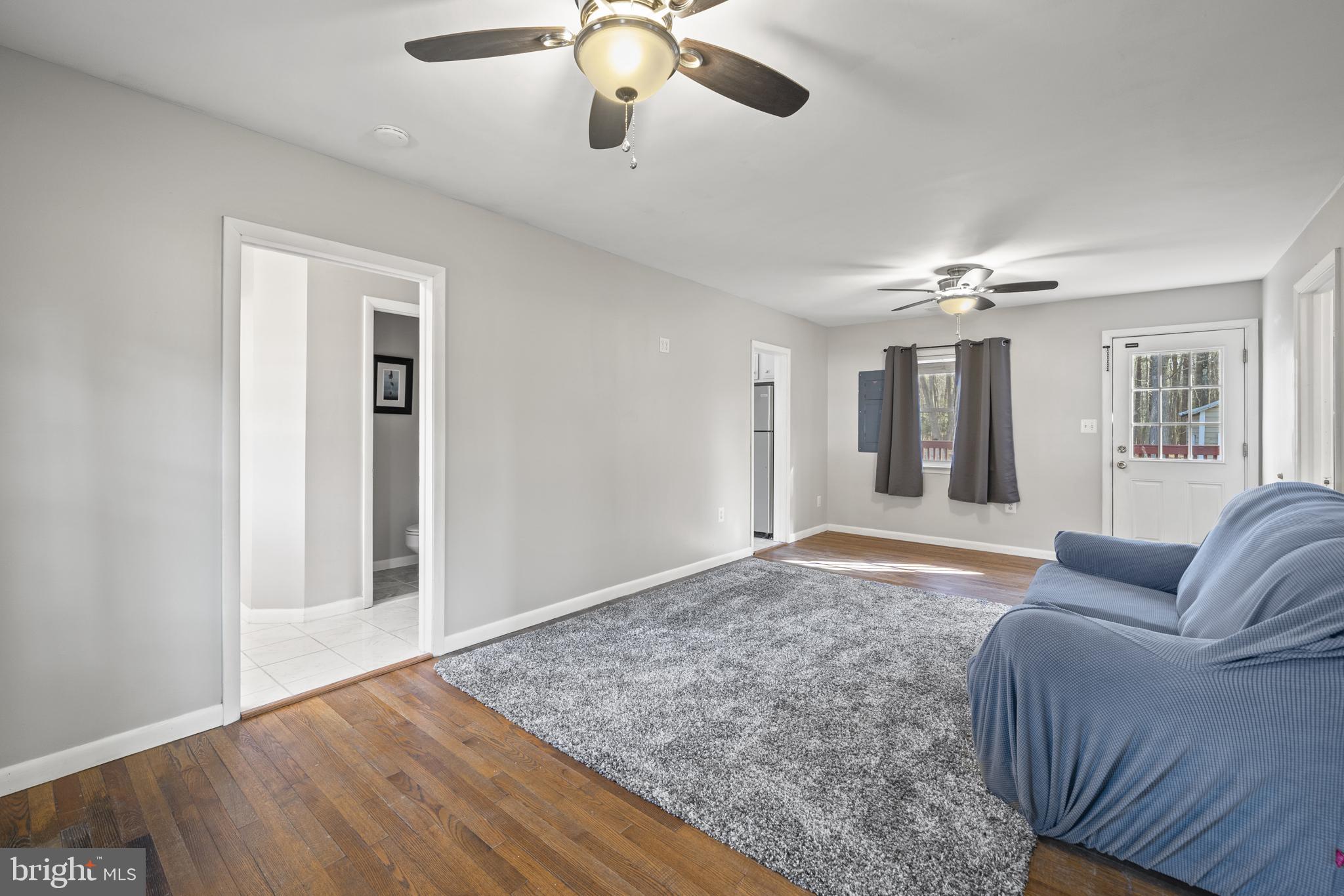 20350 Colton Point Road Coltons Point, MD 20626 - Photo 13 of 30 a living room with furniture and a chandelier