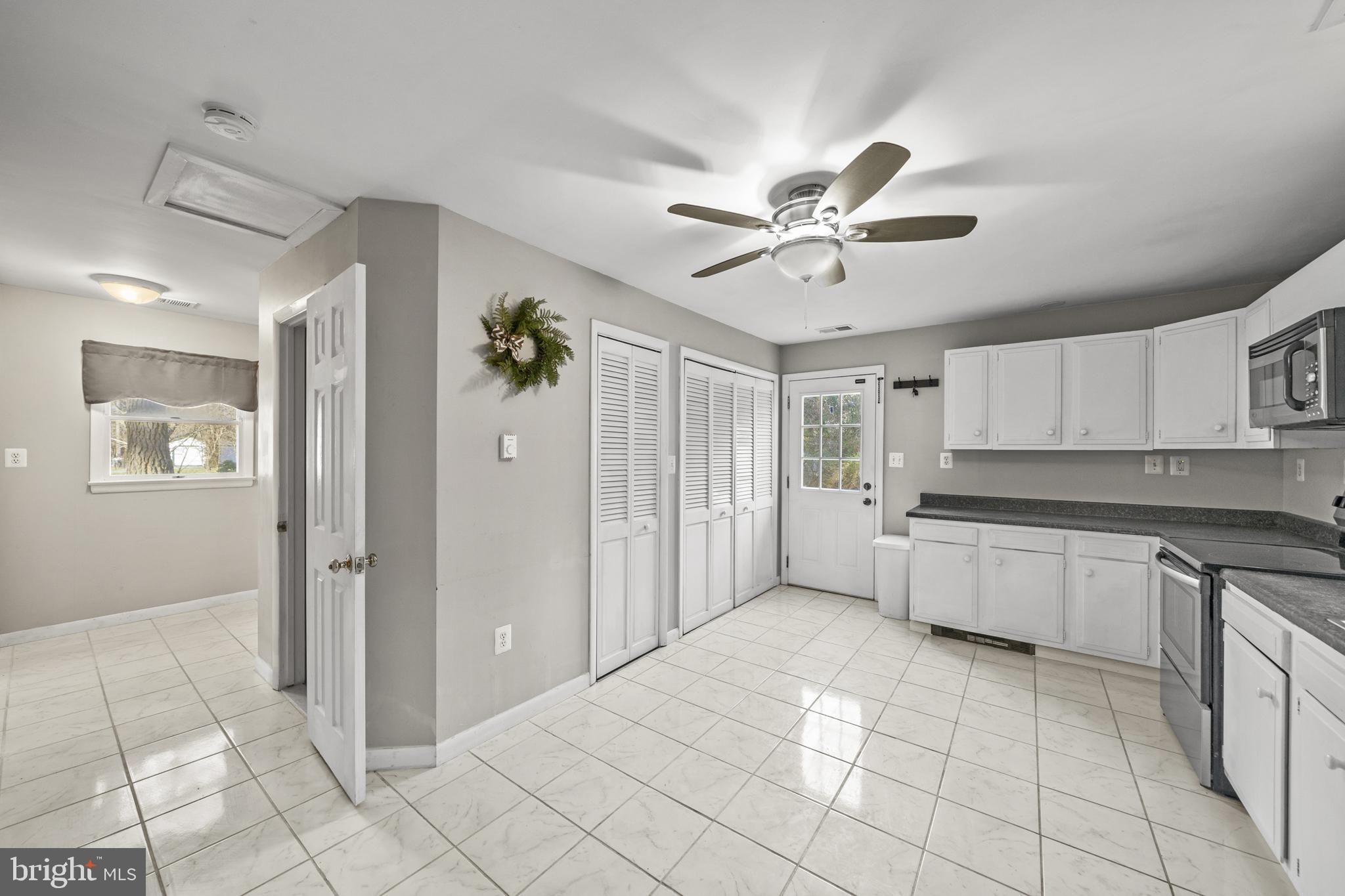 20350 Colton Point Road Coltons Point, MD 20626 - Photo 15 of 30 a large white kitchen with cabinets