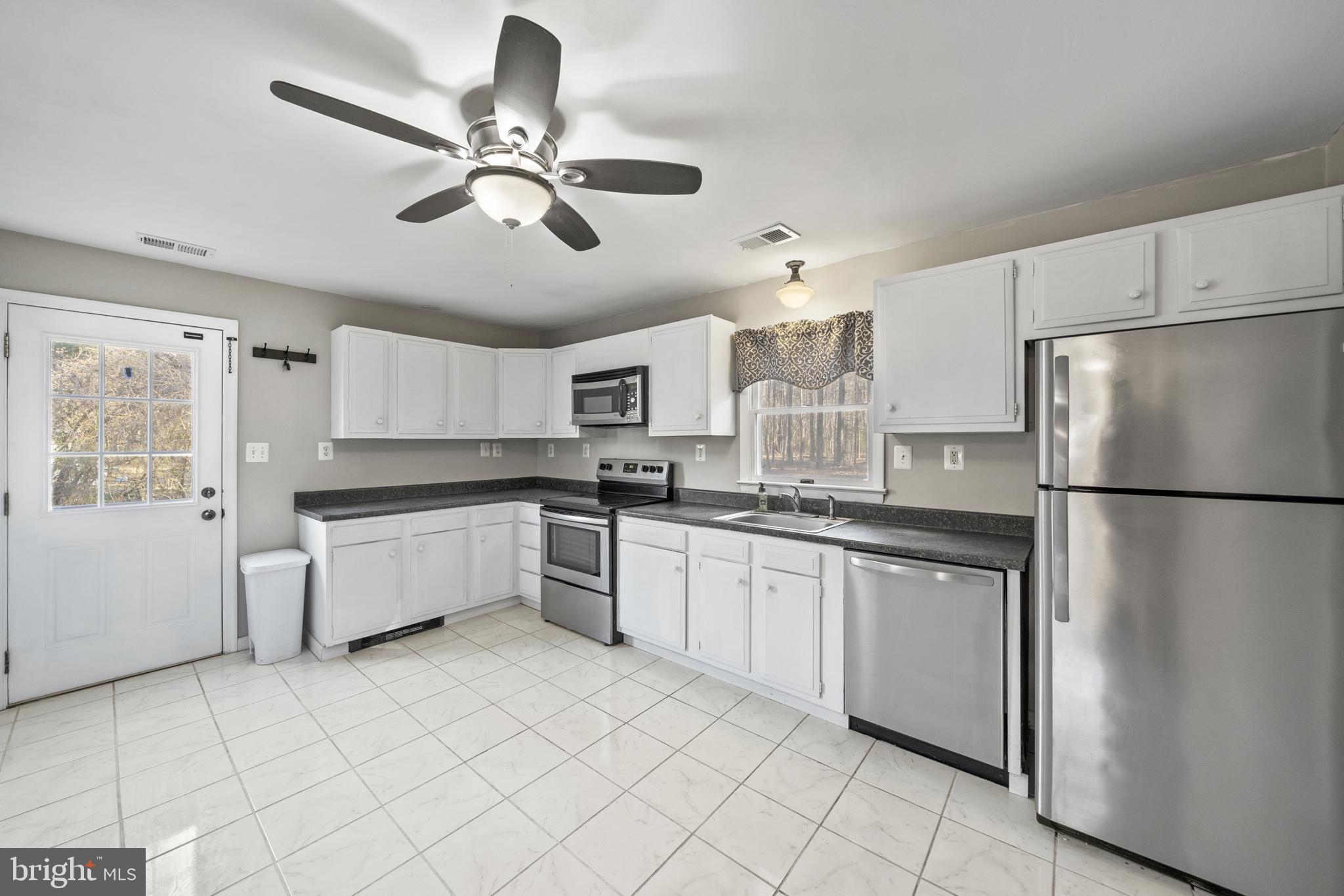 20350 Colton Point Road Coltons Point, MD 20626 - Photo 17 of 30 a kitchen with a refrigerator a sink and dishwasher